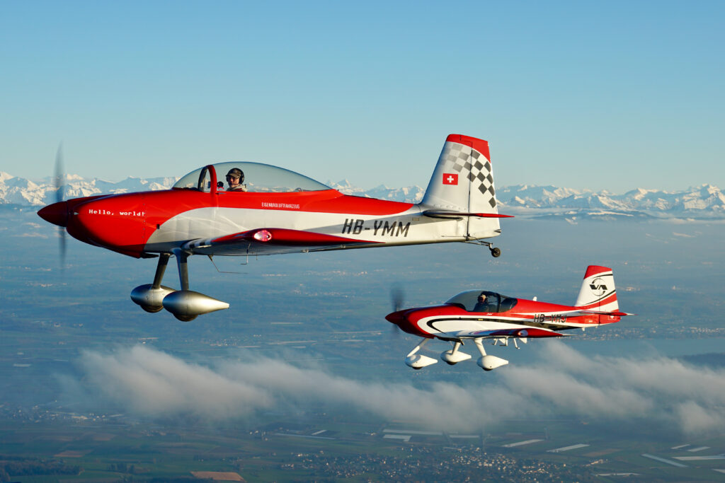 RV-8 HB-YMM and RV-14A HB-YMJ flying between the Lac de Neuchatel and the Lac de Bienne with Murtensee in the background.  Photo by Fabian Hummel.